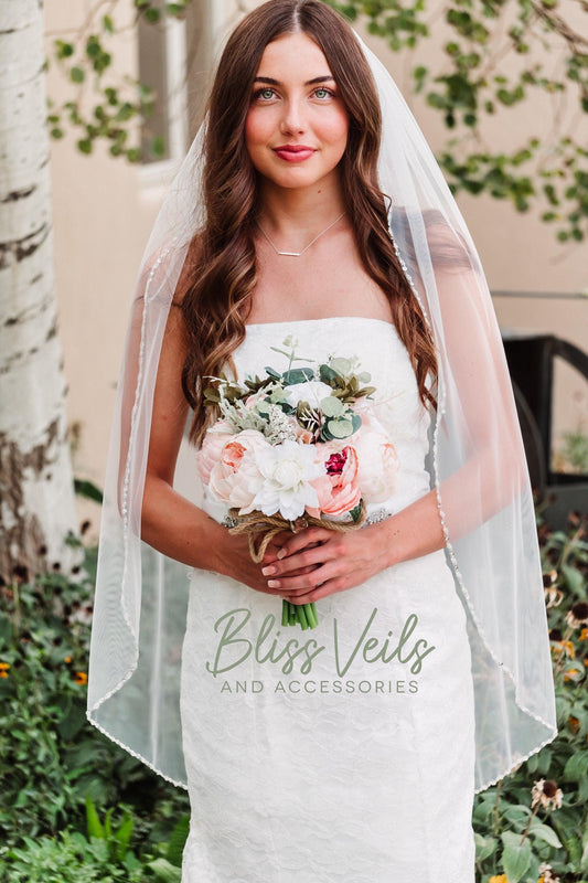 Bridal veil with crystals in fingertip or cathedral length, 1 layer, medium fullness, shown in light ivory or soft white