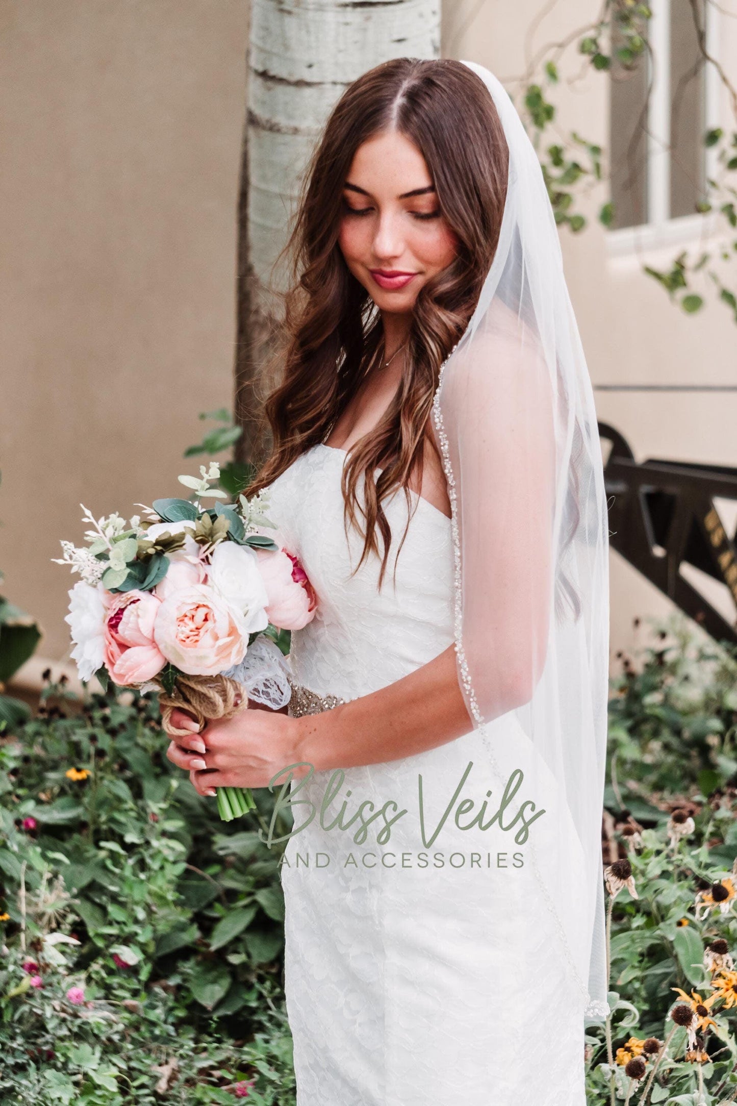 One tier pearl and crystal beaded wedding veil in fingertip and cathedral length with medium fullness, soft white or ivory, sewn to a silver comb