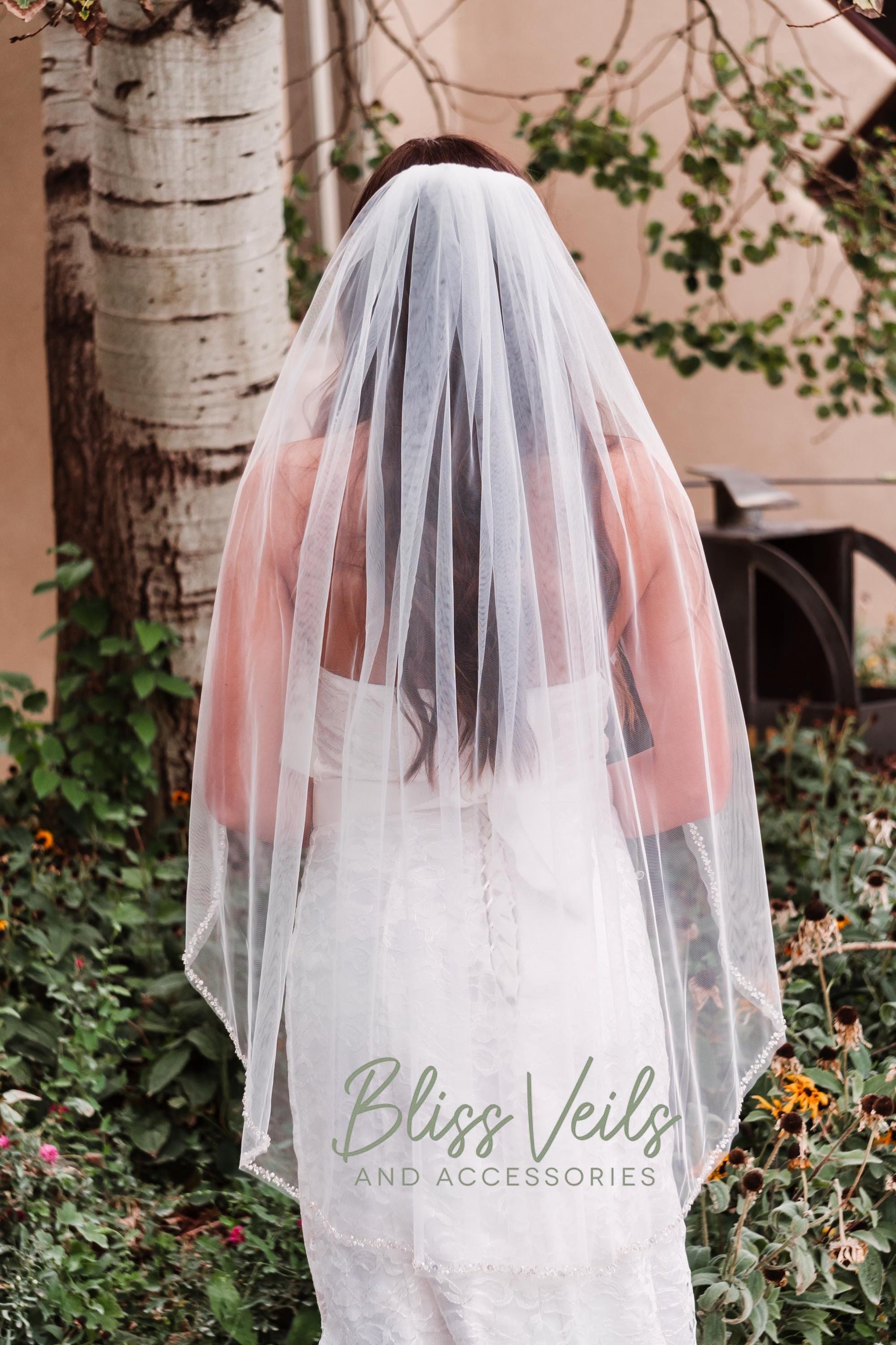 Beaded wedding veil with pearls and crystals in ivory tulle