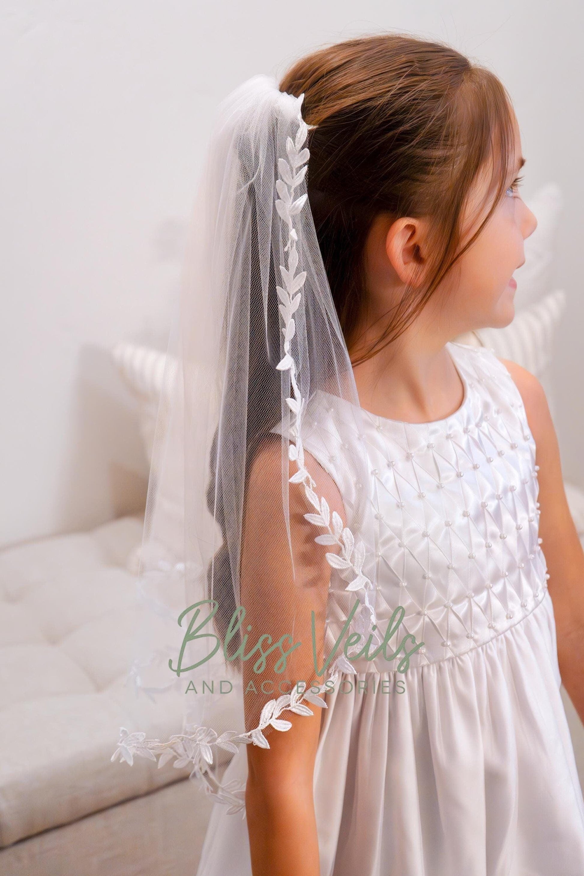 One layer First Communion veil with leaf lace edge in soft white, 20 and 25 inch lengths, attached to a metal comb