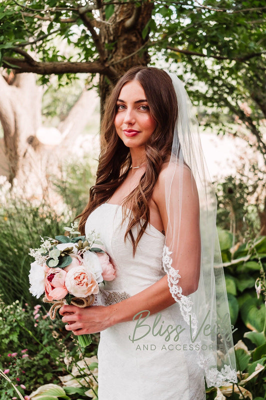 One-tier lace trim wedding veil in soft white or ivory tulle shown in fingertip length to chapel length.