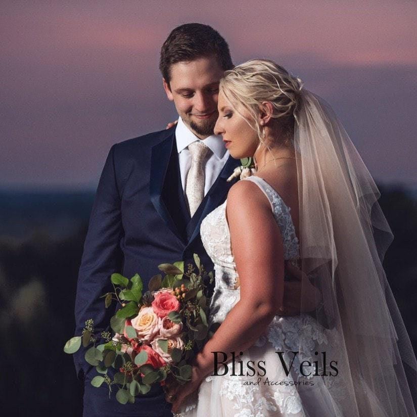 Two layer wedding veil with blusher and raw cut edge, shown in chapel length. Available in soft white, ivory, or blush