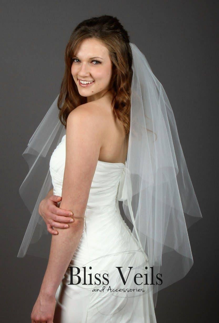 Chapel length ivory veil with clean raw edge and airy drape
