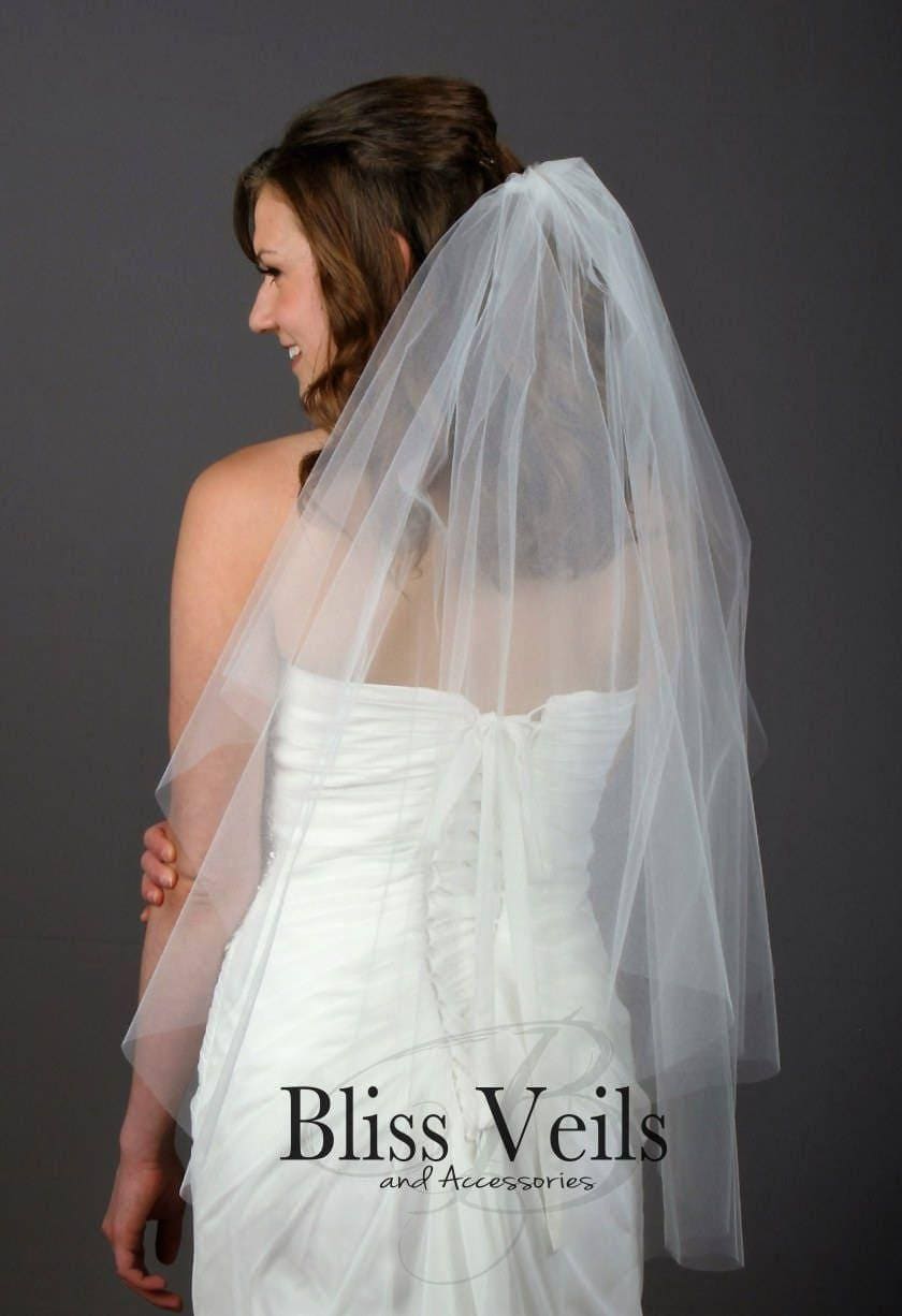 Romantic bridal veil in soft white tulle with raw cut finish