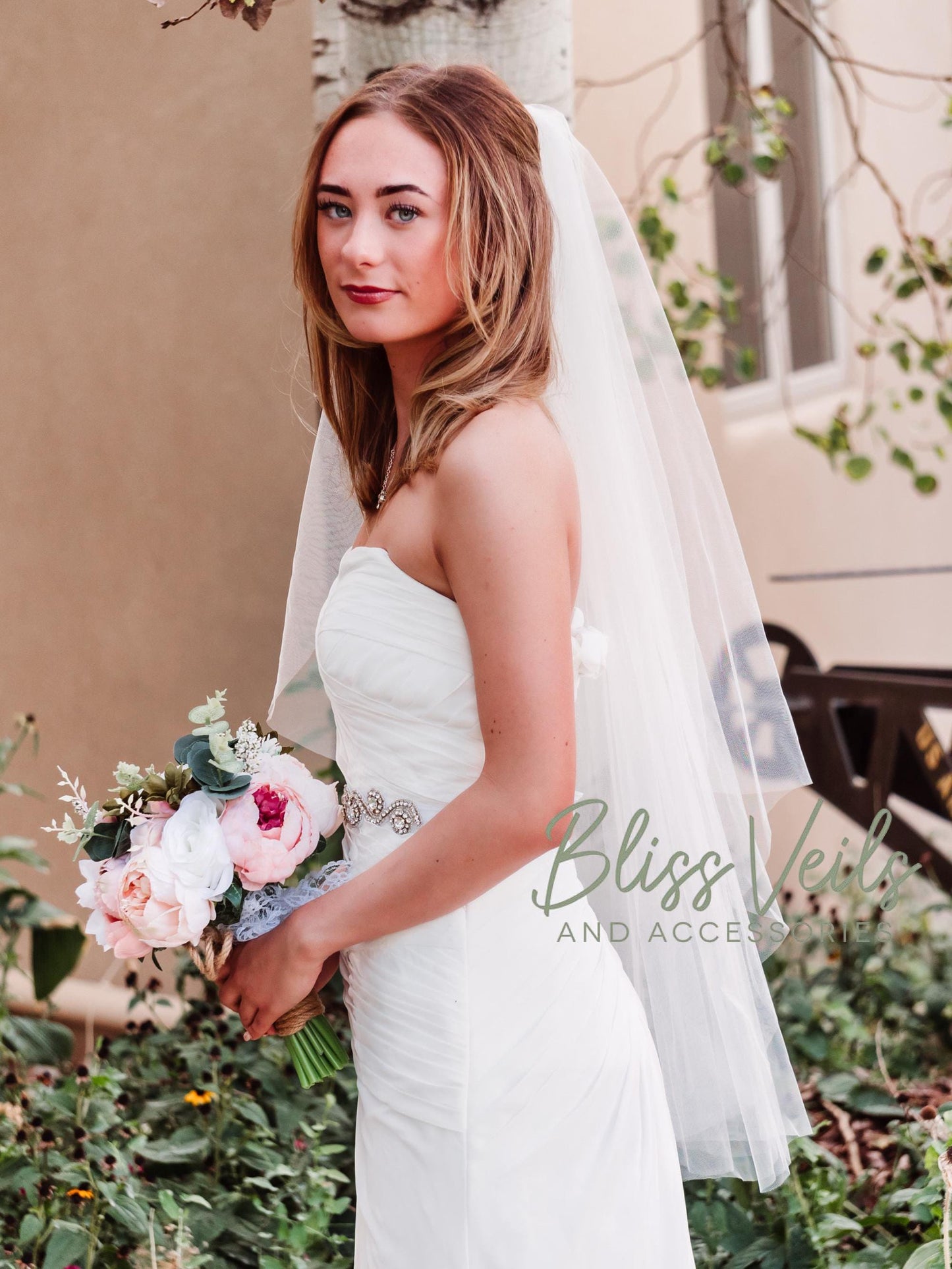 Angel cut wedding veil with rounded edge in soft white or ivory, available in fingertip, waltz, chapel, and cathedral lengths